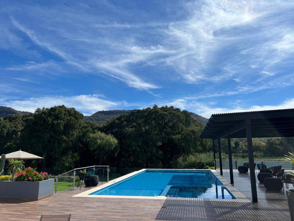 Outdoor swimming pool surrounded by gardens and Jalisco mountain views